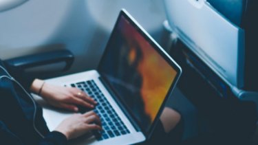 Two hands typing on a laptop