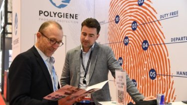 two men looking to a brochure