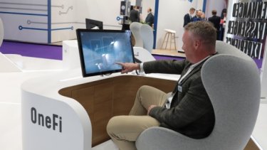 Man in seat using OneFi desk