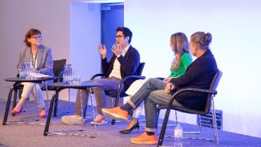 four people on a stage talking at PEC