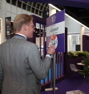 man tapping his QR with lanyard to a digital capture device