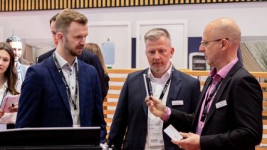 three men exhibitors meet up
