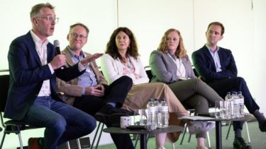 five people on a stage talking at PEC