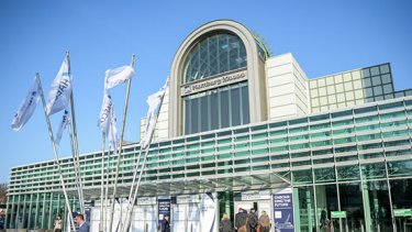 Building of Hamburg Messe with white Hamburg flags outside