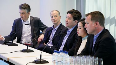 people in a suits sitting and talking.
